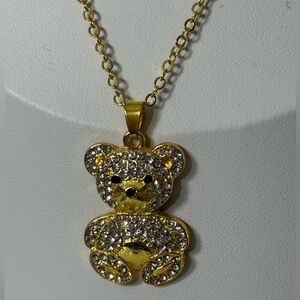 Gold-tone teddy bear necklace with shiny inlays. Cute and elegant design